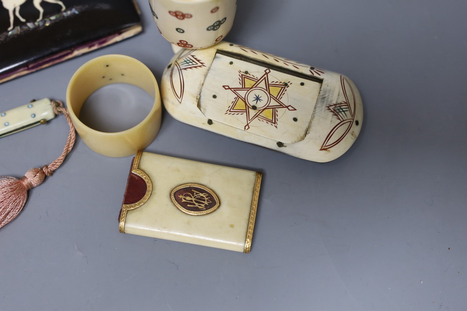 A George III ivory needle case, 6cm. a Victorian card purse inlaid with a whippet, 9.5cm, a horn snuff box and four other items.